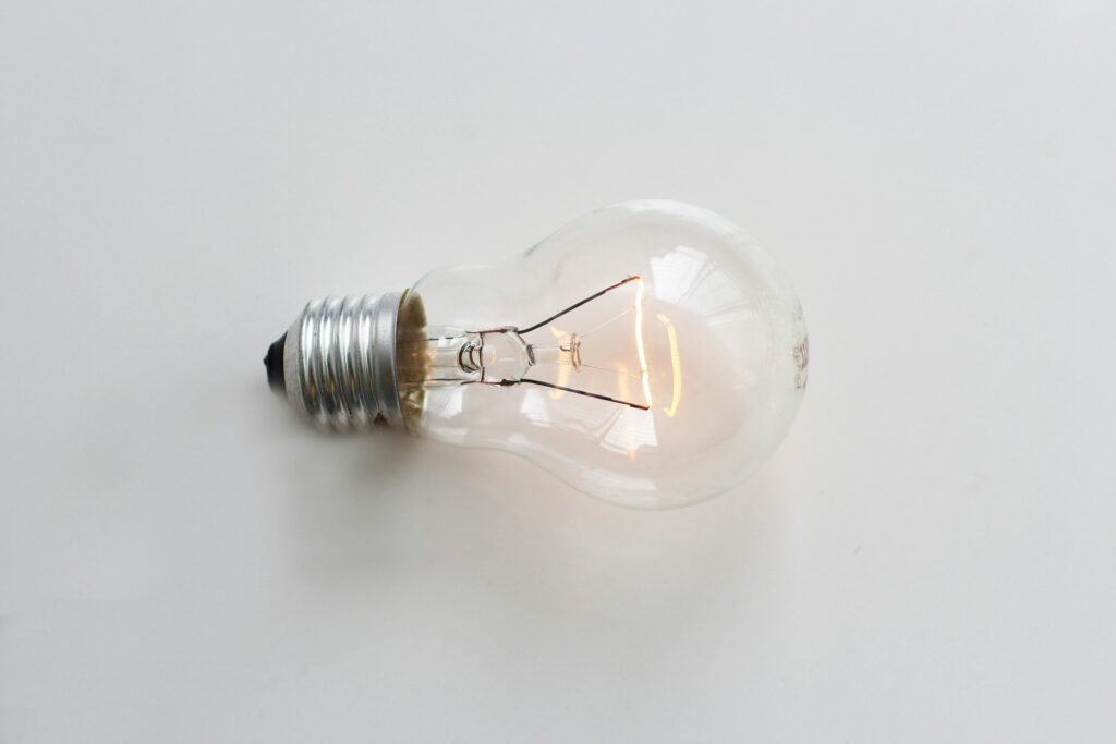 pexels-photo-269318-269318 A close-up of an illuminated incandescent light bulb against a white background.