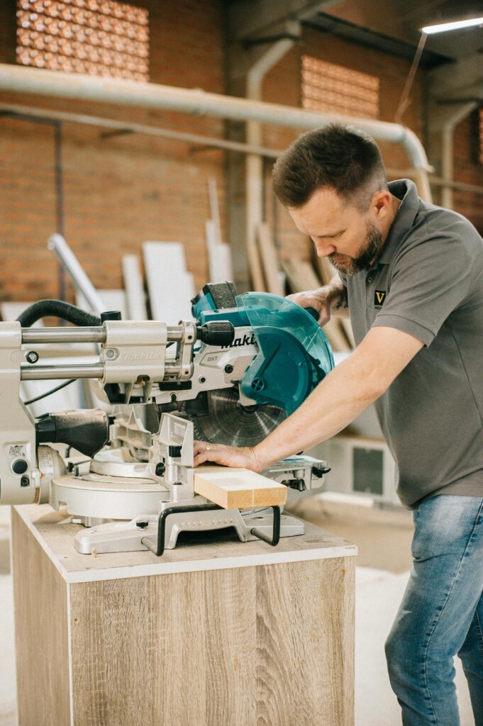 pexels-photo-28513060-28513060 Carpenter using a circular saw in a workshop setting, focusing precision.