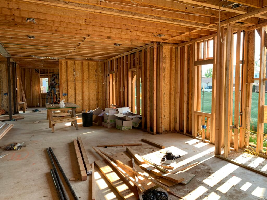 pexels-photo-4642438-4642438 Sunlit interior with wood framing, showcasing home construction progress.