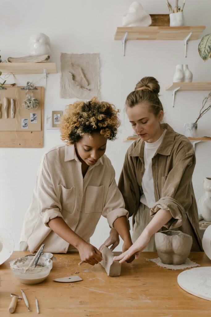 pexels-photo-6694304-6694304 Two women sculpting clay in a pottery workshop, showcasing creativity and craftsmanship.