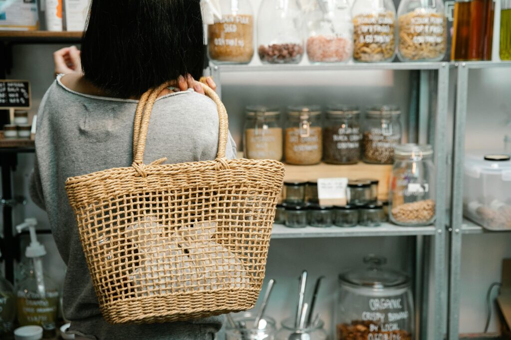 pexels-photo-7263005-7263005 A woman with a wicker bag shops for organic products in a zero waste store.