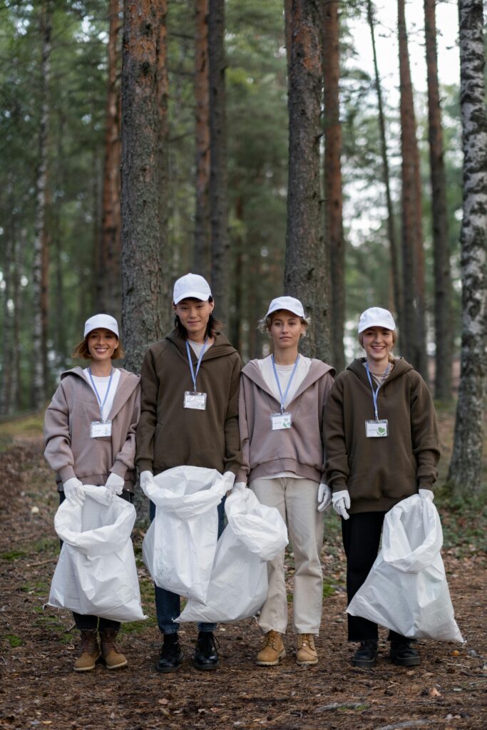 pexels-photo-9543406-9543406 A group of young volunteers cleaning a forest area, promoting conservation efforts.
